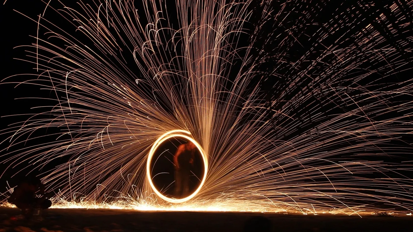 Sparks fly as a fire-dancer performs a traditional dance in Port Vila, Vanuatu. Image credit: stock.adobe.com