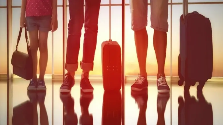 Silhouetted legs and bags of a family at airport. Get Jetstar's tips on surviving the airport with your family!