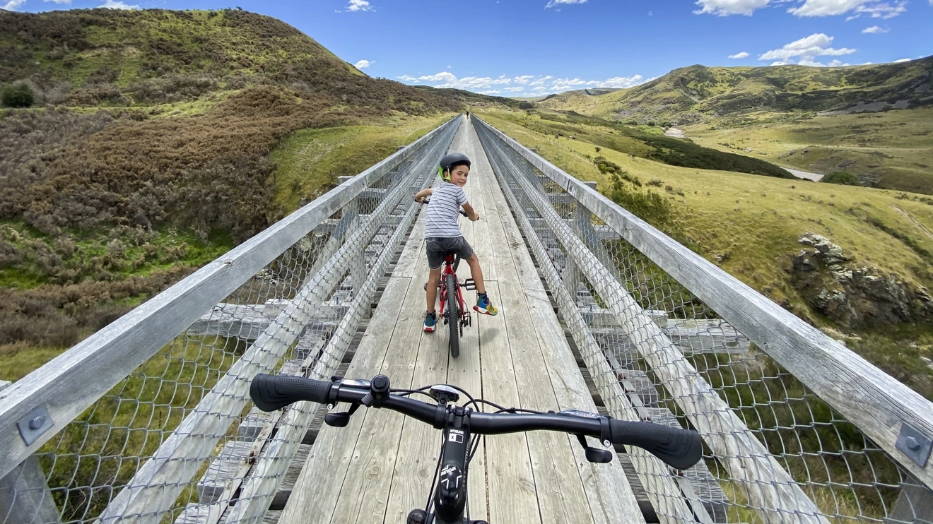 A child on a bike on the Otago Central Rail Trail. Image credit: Dunedin NZ