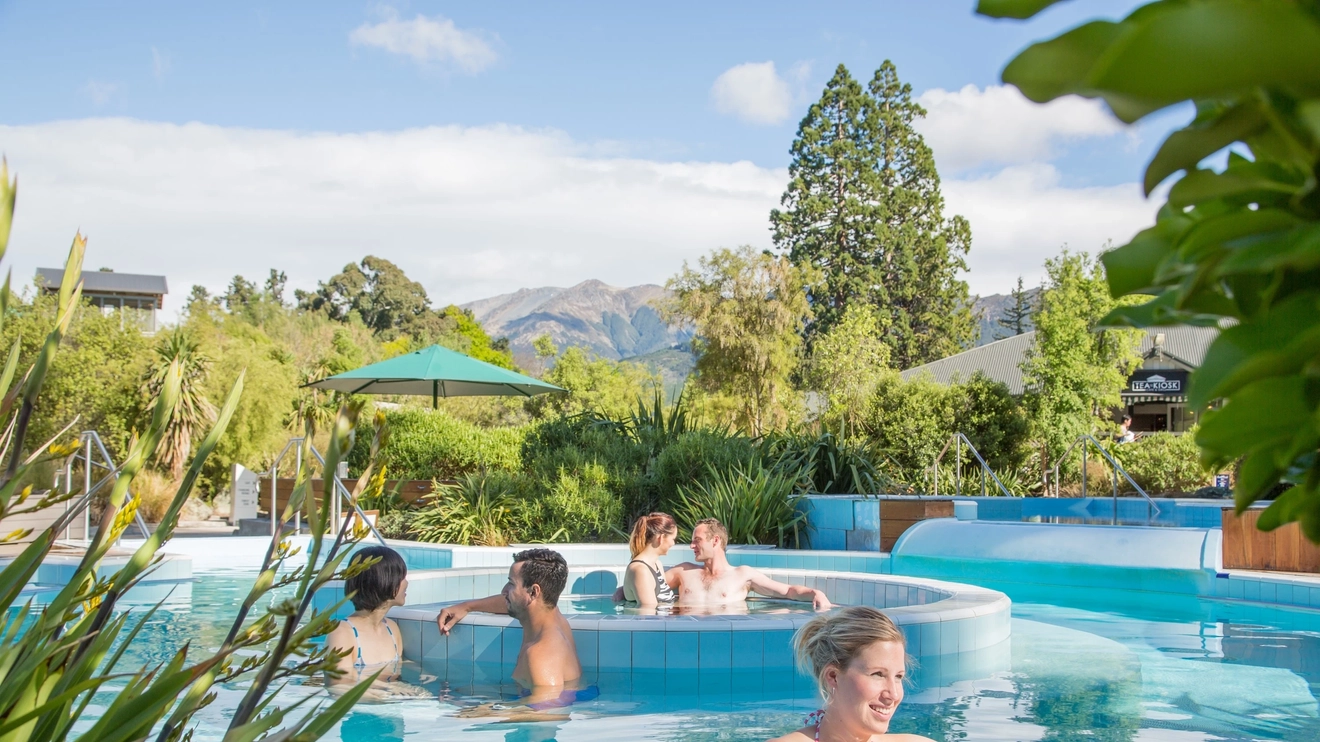 People relaxing in a series of hot pools at Hanmer Springs, New Zealand. Image credit: Hanmer Springs