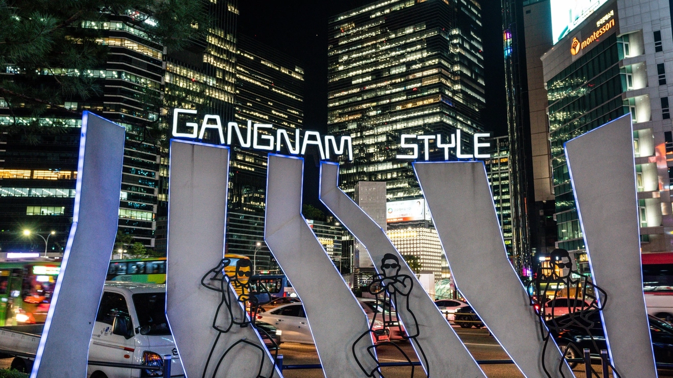 Gangnam Style neon lights at Gangnam Square, with buildings in background at night in Seoul, South Korea. Image credit: Keitma – stock.adobe.com