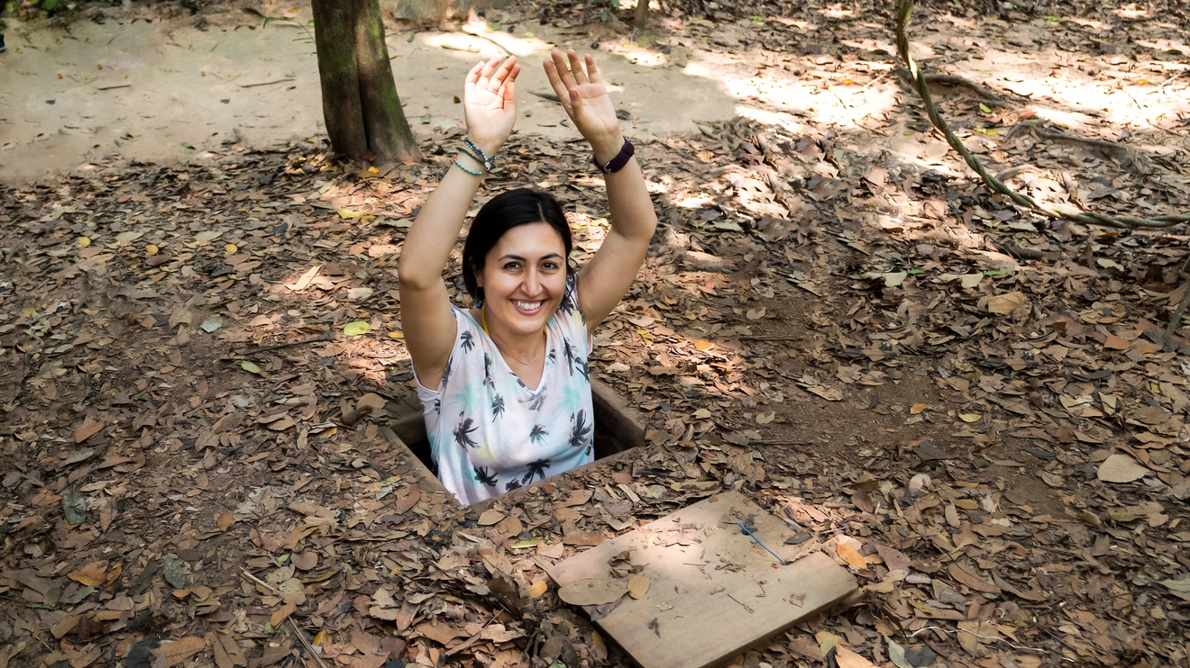 A female tourist poses in the entrance to one of Ho Chi Minh City’s historic Cu Chi tunnels. Image credit: stock.adobe.com