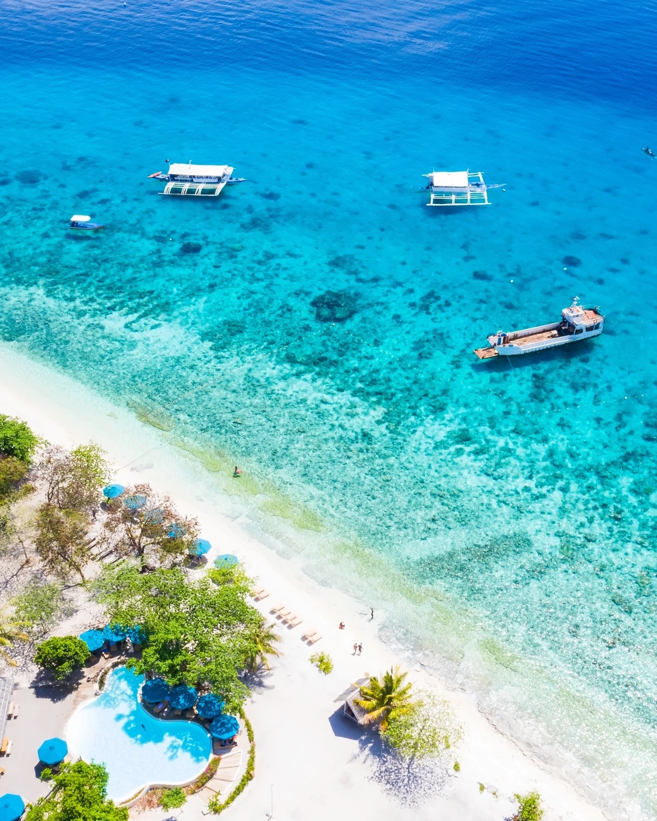 Aerial view of the heavenly aquamarine water and white sand of Oslob beach, Sumilon Island, Cebu. Image credit: stock.adobe.com