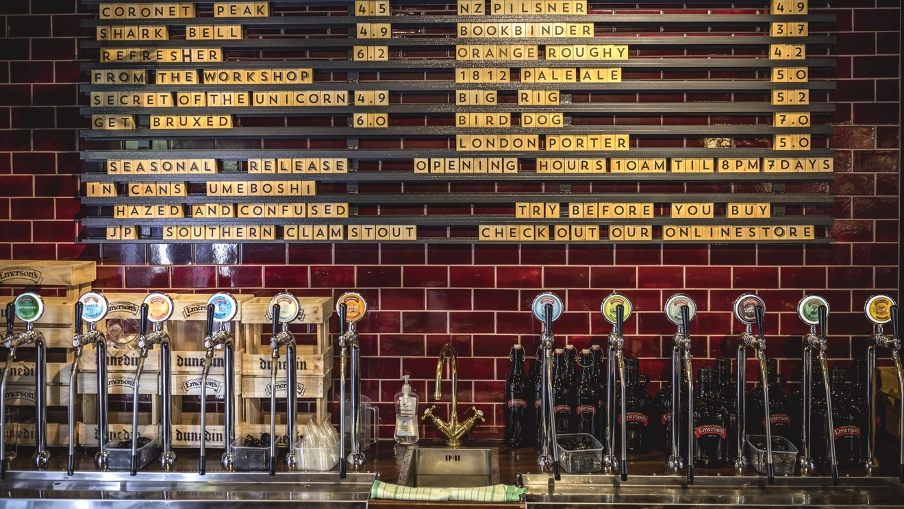 A wall-mounted drinks board listing craft beers at a brewery-bar in Dunedin, New Zealand. Image credit: Miles Holden