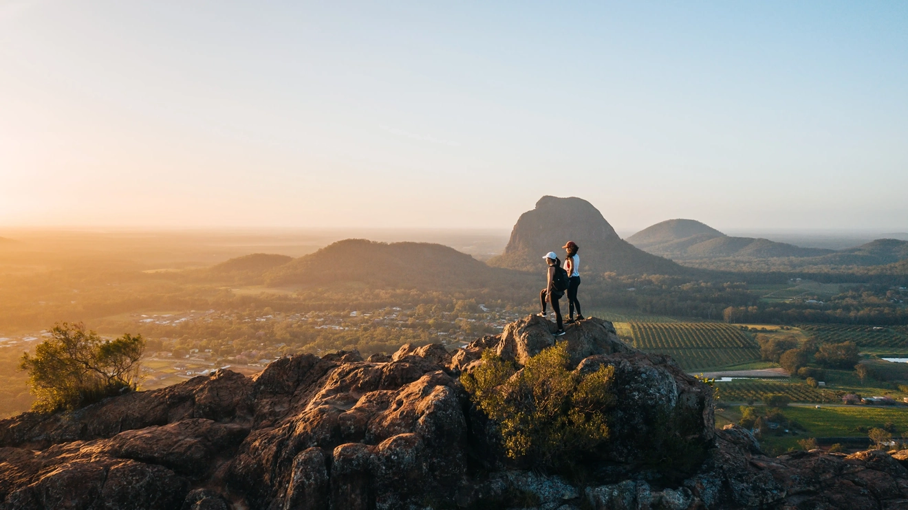 Hikers at the summit of Mount Ngungun in the Glasshouse Mountains at sunrise. Image credit: Tourism and Events Queensland
