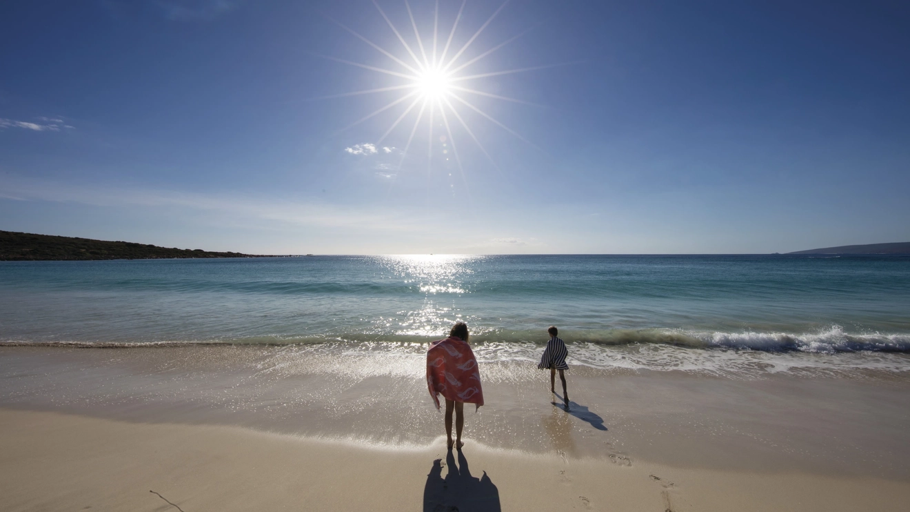 Two children run towards the perfectly calm, turquoise water, Smith's Beach. Image: Tourism Western Australia