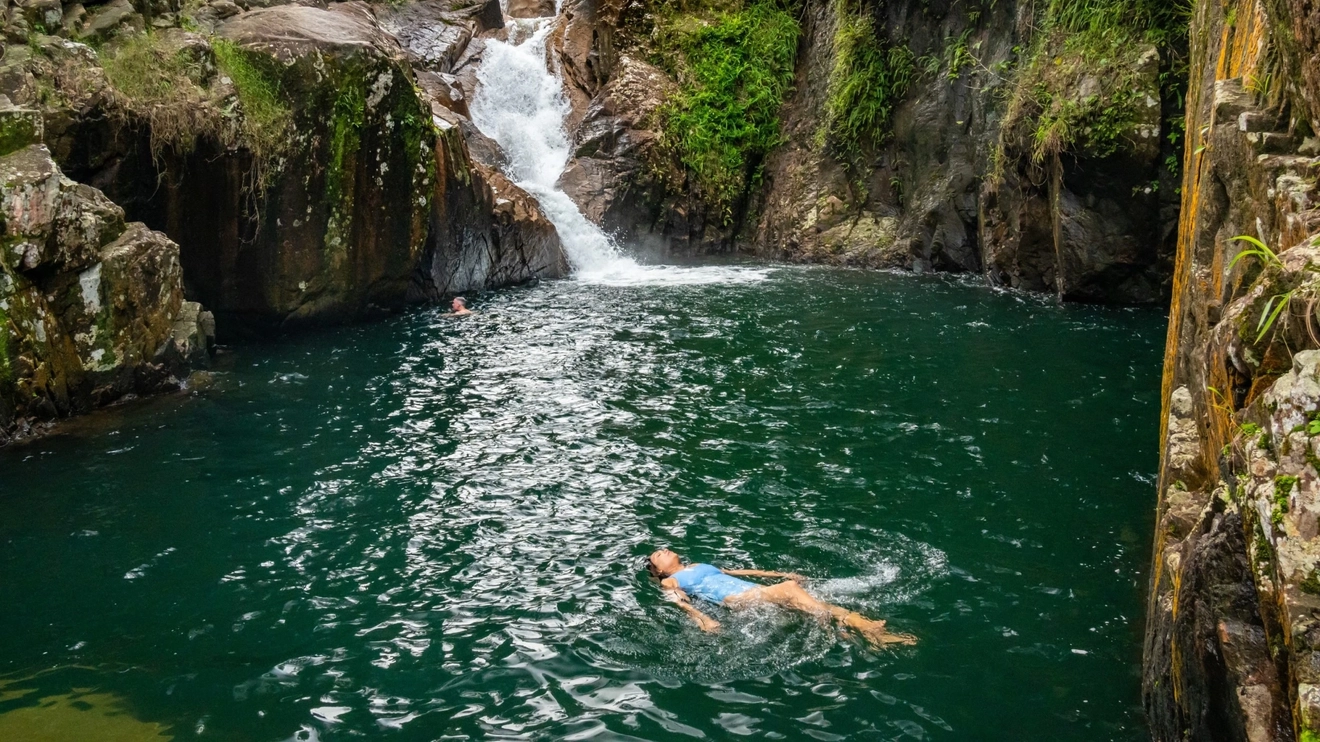 Woman floating in rockpool at Finch Hatton Gorge, Mackay area. Image credit: Tourism and Events Queensland