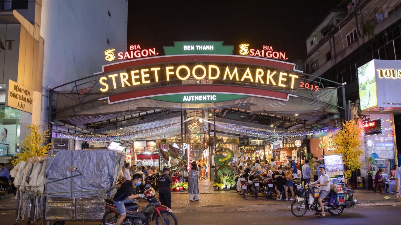 Illuminated entrance to Ben Thanh night market, Ho Chi Minh City. Image credit: carol_anne - stock.adobe.com