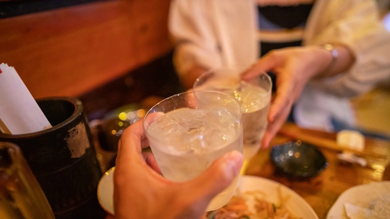 A celebratory toast with Japanese 'Awamori' alcohol in Okinawa.