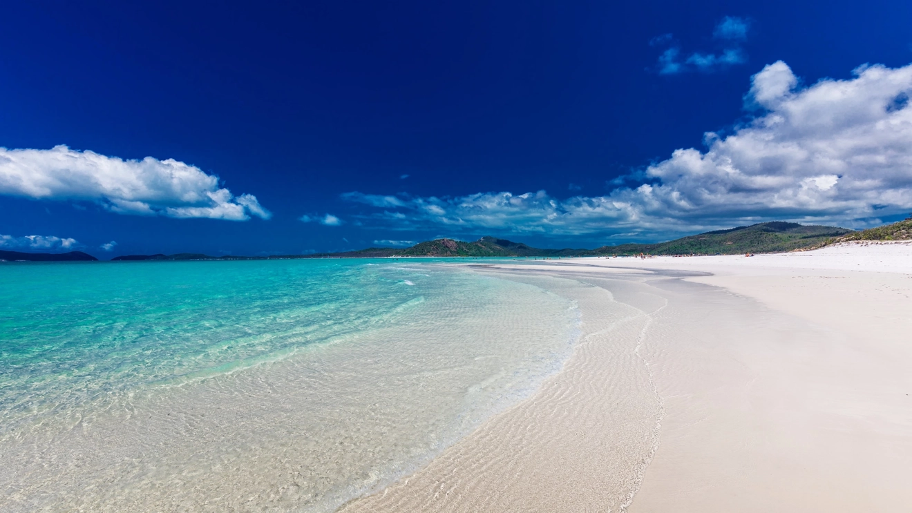 Whitehaven Beach with white sand and blue sky, Whitsunday Coast, Queensland. Image credit: stock.adobe.com