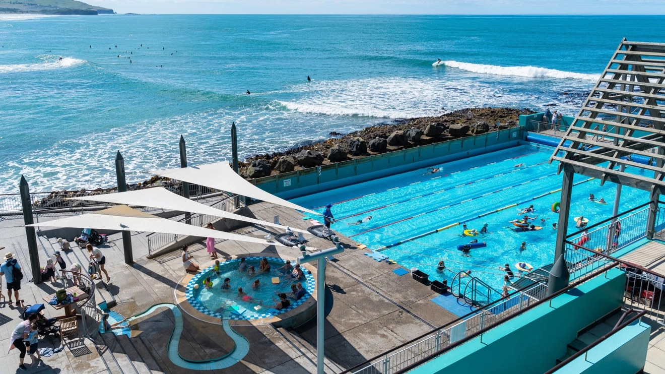 Aerial shot of hot water pool with toddler pool looking out onto the Pacific Ocean, St Clair Hot Saltwater Pool. Image credit: Dunedin NZ