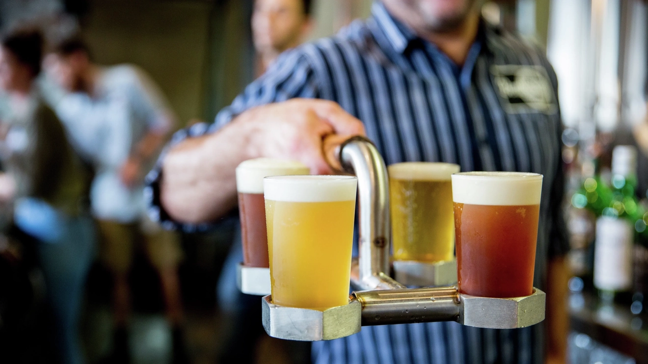 Close-up of four beers in a metal holder at Bentspoke Brewpub, Braddon, Canberra. Image credit: Visit Canberra