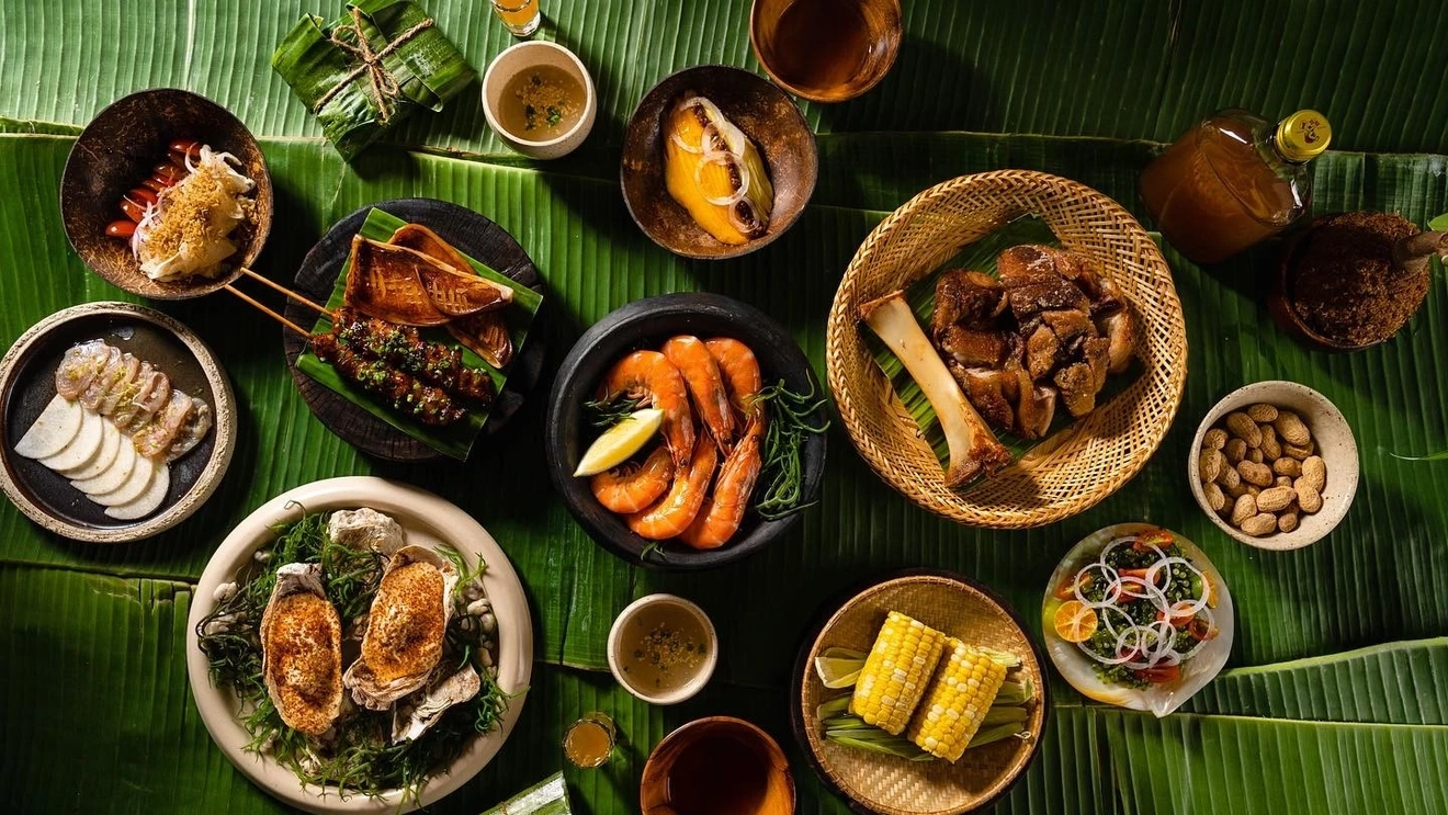 A kamayan spread of Filippino dishes laid out in on small dishes on banana leaves. Image credit: Toyo Eatery